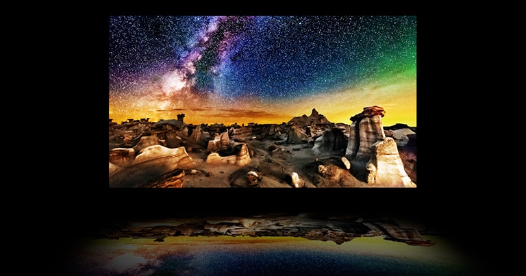 A video of a TV's layers with a starry nighttime landscape photograph on the main OLED display. The backlight disappears, and the polarizer, colour filter, and OLED come together to produce an image so bright that it reflects below the TV like on water.