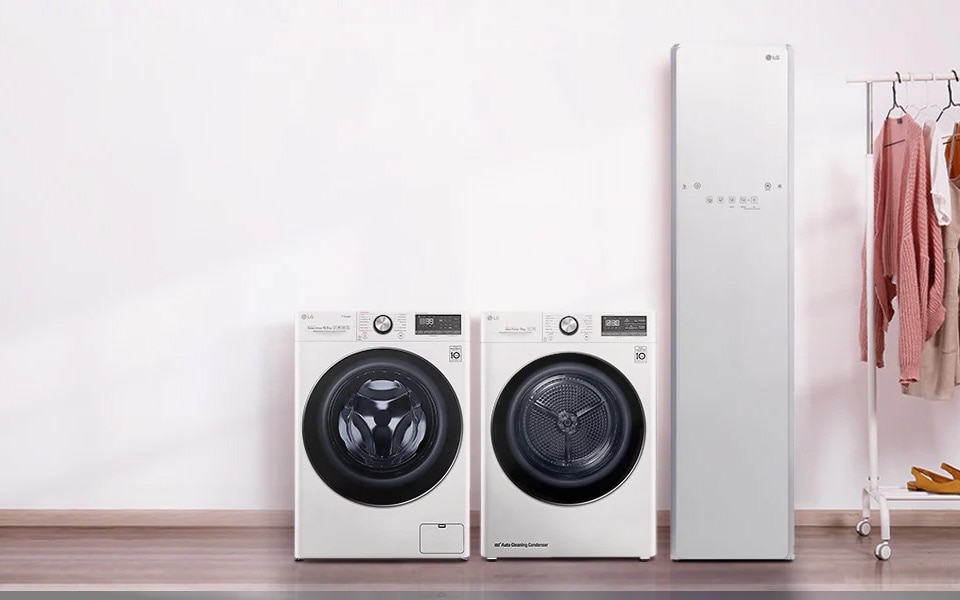 A clothes hanger is placed beside two LG washing machines and LG Styler
