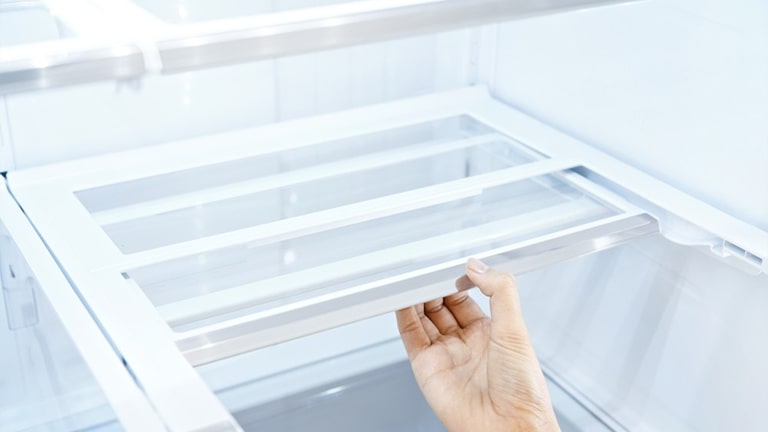 Pulling the sliding compartment in the refrigerator with your hand