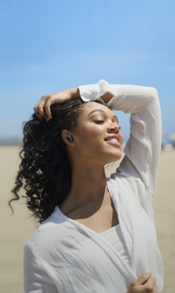A woman is listening music with LG TONE Free